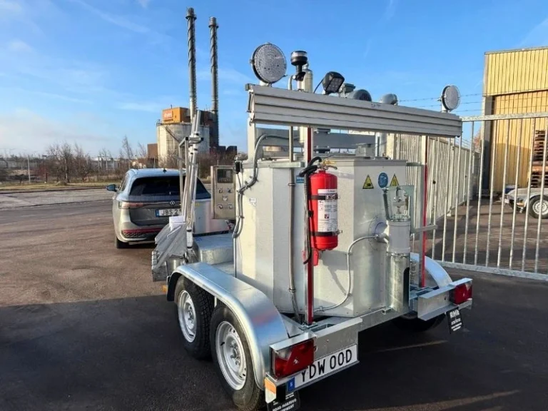 RME twin-axle road marking trailer with a mounted preheater unit, coupled ready to tow